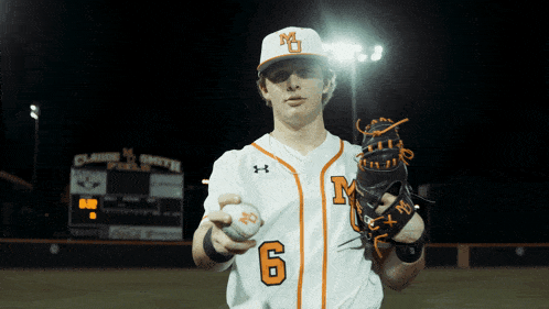a baseball player with the number 6 on his jersey holds a ball