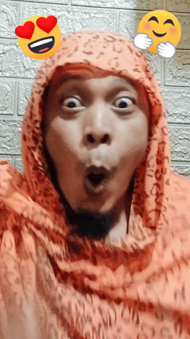 a man wearing a leopard print scarf makes a funny face