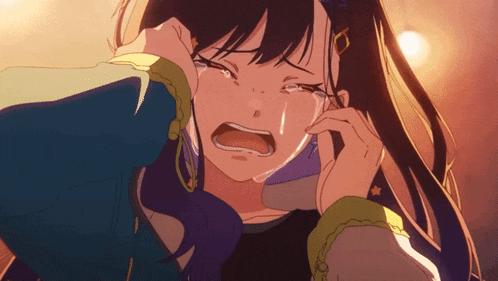 a girl is crying and covering her face with her hand