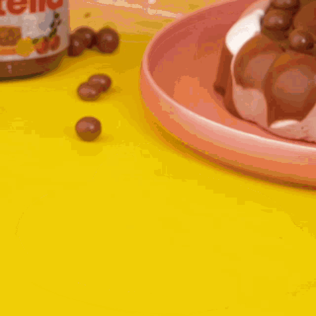a bottle of nutella next to a plate of chocolate