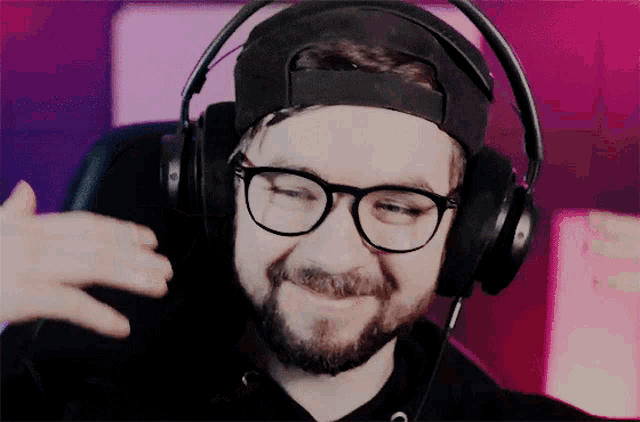 a man with a beard wearing headphones and glasses