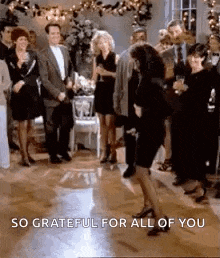 a woman is dancing on a dance floor at a party with a group of people .