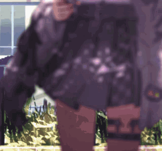 a blurry picture of a person with a purple jacket on