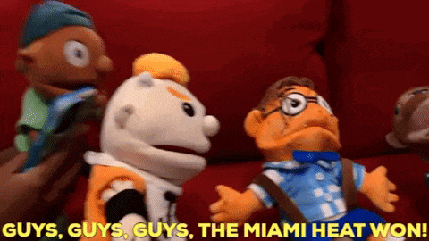 a group of stuffed animals are sitting on a red couch with the caption guys guys guys the miami heat won .