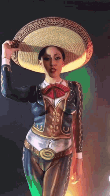 a woman with her body painted in a mariachi outfit is holding a sombrero