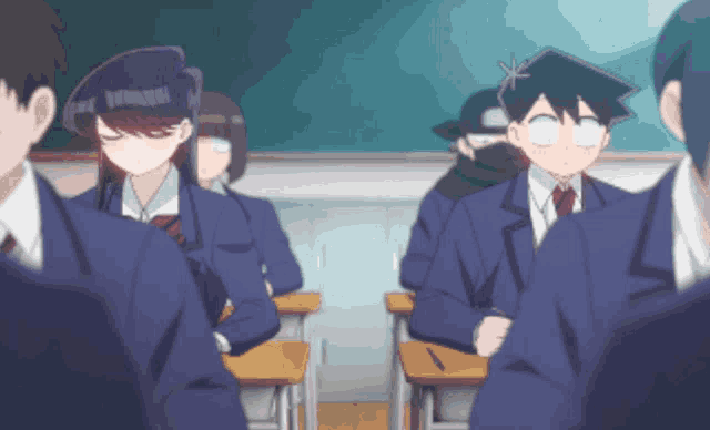 a group of students are sitting in a classroom and one of them is wearing a mask