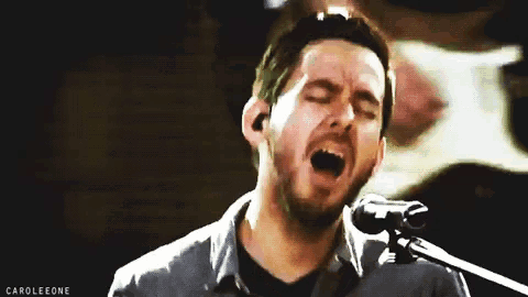 a man singing into a microphone with the words caroleone written below him