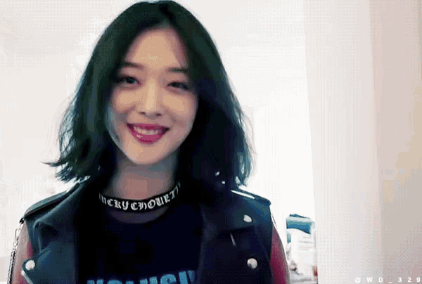 a woman wearing a choker that says lucky chowett smiles for the camera