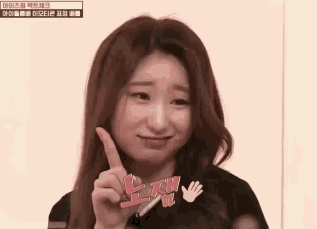 a woman is making a funny face while holding up her finger and a hand with the letter h on it