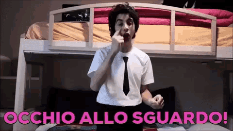 a man in a white shirt and tie is standing in front of a bunk bed with the words occhio allo sguardo written in pink