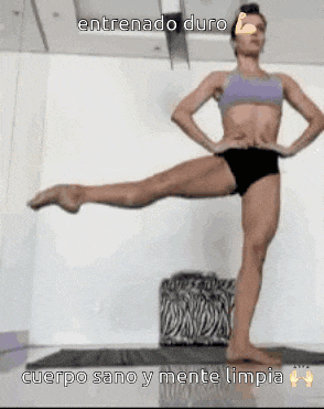 a woman in a bikini is doing a yoga pose on a mat .