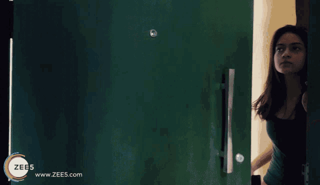 a woman is standing in front of a door with the words what if that boy tanie falls