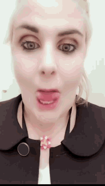 a woman making a funny face with her tongue out