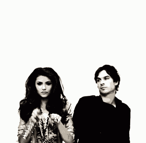 a man and a woman are standing next to each other on a white background and smiling .