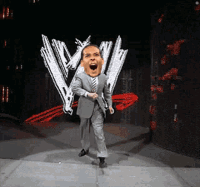 a man in a suit and tie dancing in front of a w logo
