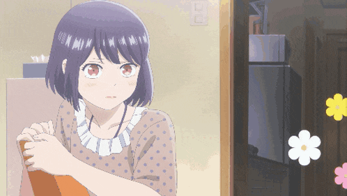 a girl in a polka dot shirt stands in front of a fridge with flowers on it