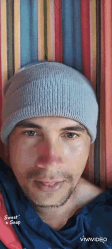 a man wearing a beanie is laying in a hammock with the words sweet snap on the bottom