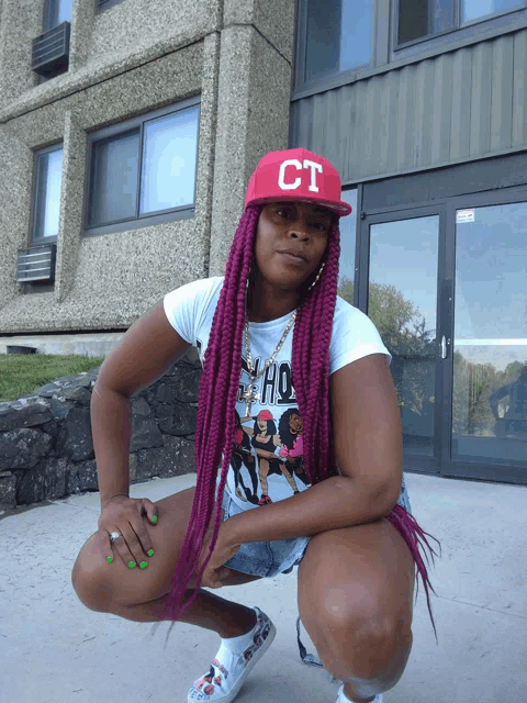 a woman wearing a red hat that says ct