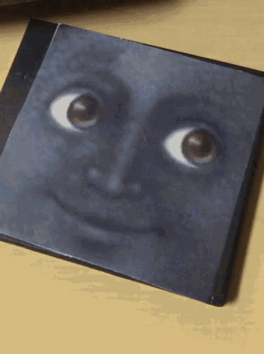 a picture of a face with big eyes on a table