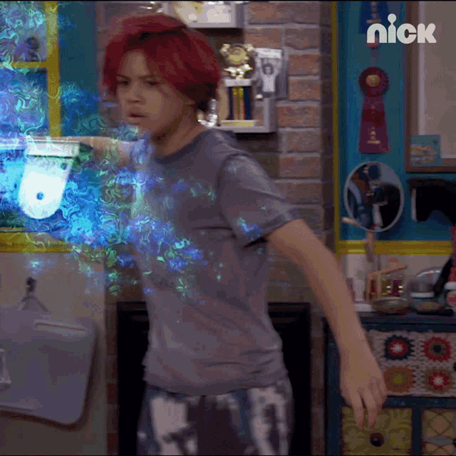 a person with red hair is standing in front of a wall with a nick logo on it