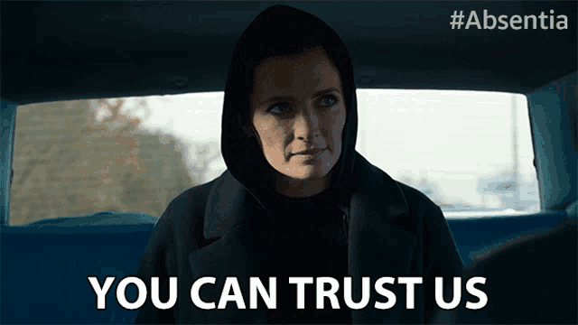 a woman sitting in a car with the words you can trust us