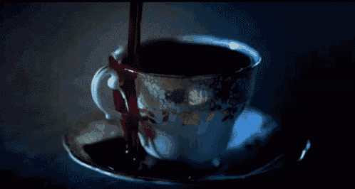 blood is being poured into a cup of tea