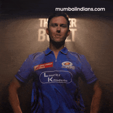 a man wearing a blue shirt that says lauritz knudsen on it