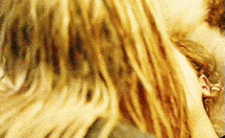 a close up of a person 's hair with a blurry background .
