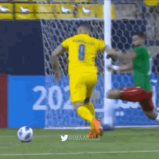 a soccer player with the number 9 on his jersey kicks the ball