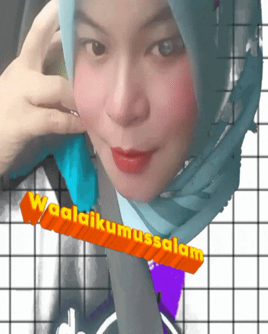 a woman wearing a blue scarf with the words waalaikumussalam written on it