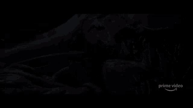 a person laying on a couch with blood on it and the words prime video on the bottom