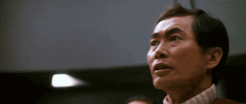 a close up of a man 's face looking up at something