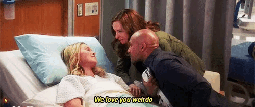 a woman in a hospital bed with the words we love you weirdo on the bottom