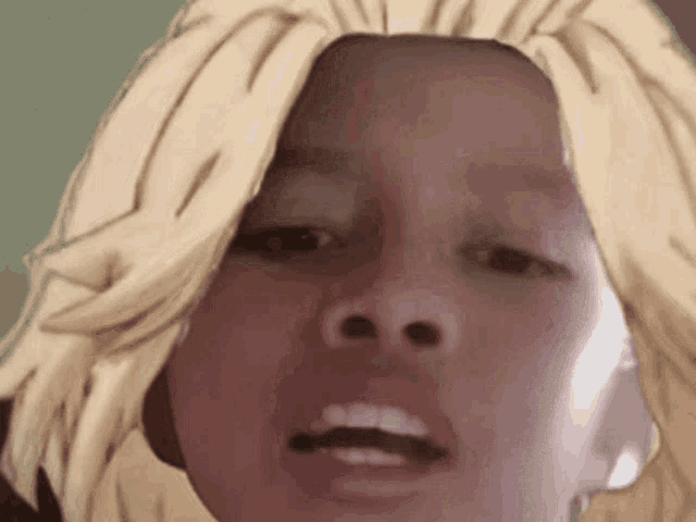 a close up of a person with blonde hair