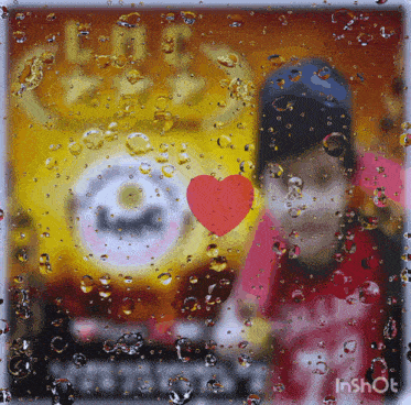 a picture of a person behind a window with bubbles and a red heart