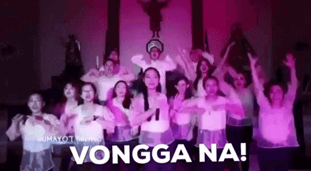 a group of people are dancing in a church with the words vongga na written in the foreground .