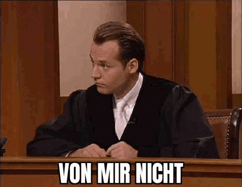 a man in a judge 's robe is sitting in a courtroom with the words von mir nicht written on the screen .