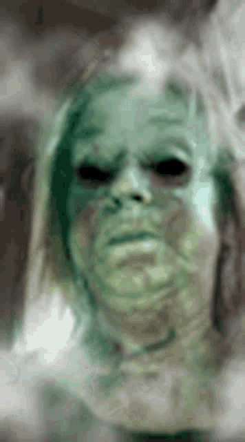 a close up of a person 's face with a ghostly look on it .