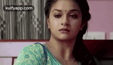 a close up of a woman 's face with a tear running down her face .