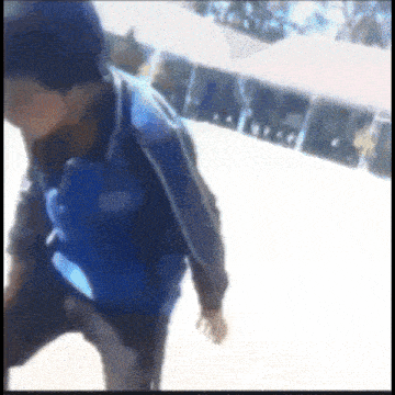 a blurry picture of a person wearing a blue jacket