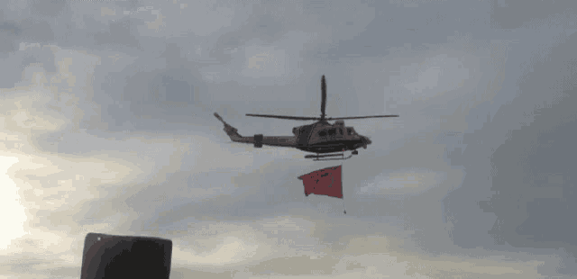 a helicopter with a flag attached to it