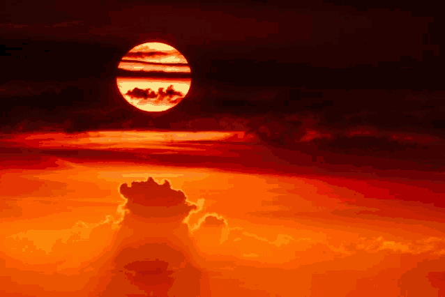 the sun is setting behind some clouds in a sunset