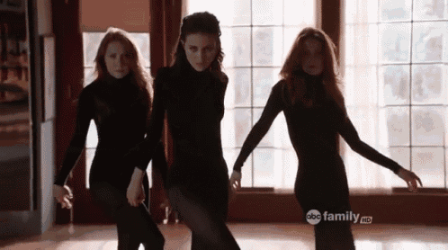 three women are dancing in front of a window with the abc family hd logo