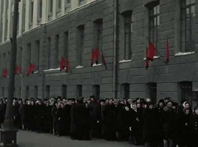 a large group of people are standing in front of a building