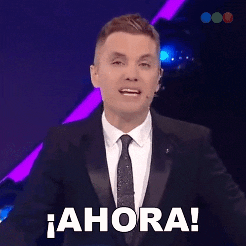 a man in a tuxedo and tie says ahora