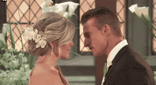 a bride and groom looking into each other 's eyes