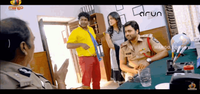 a man in a yellow shirt is standing next to a man in a police uniform