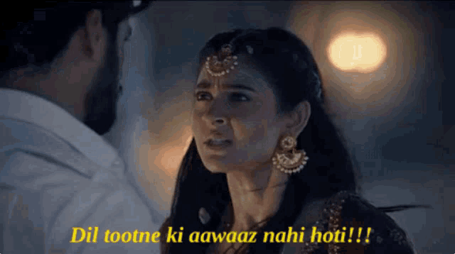 a man and a woman are looking at each other and the woman says dil tootne ki aawaaz nahi hoti !!!