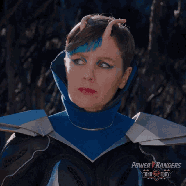 a woman in a power rangers costume stands in front of a tree