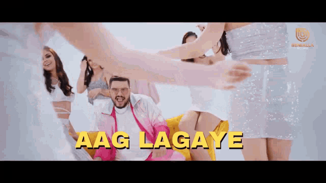 a man is surrounded by women and the words aag lagaye are visible